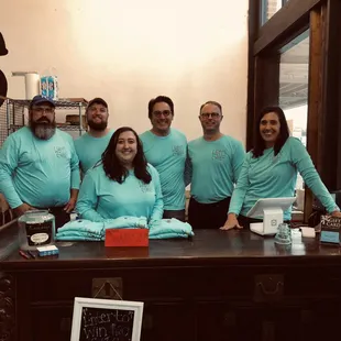 a group of people in blue shirts