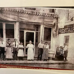a group of people standing in front of a restaurant