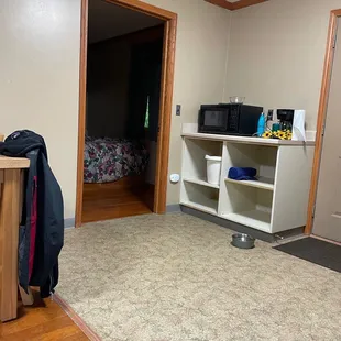 Microwave, coffee maker and glimpse of bedroom
