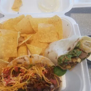 Teriyaki Steak Sriracha taco and half of the bourbon chicken wrap with chips