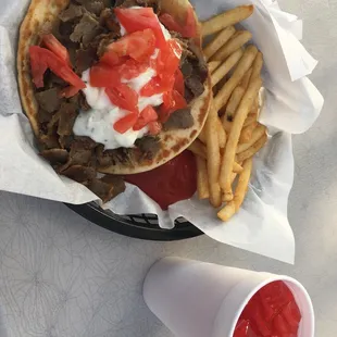 a plate of fries and a cup of ketchup