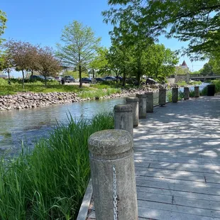 a man sitting on a bench overlooking a river