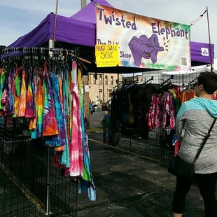 a man and a woman standing in front of a vendor