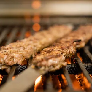 the meat being cooked on the grill