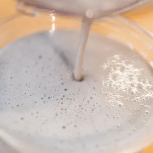 milk being poured into a cup