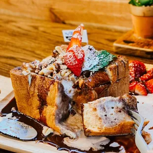 a plate of french toast and strawberries
