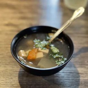 a bowl of soup on a wooden table