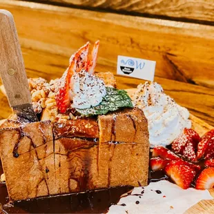 a piece of bread with whipped cream and strawberries