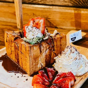 a piece of bread with whipped cream and strawberries