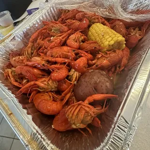 4lb of spicy crawfish to go! Two pans included two large potatoes, two corn and two decent sized pieces of sausage. Delicious.