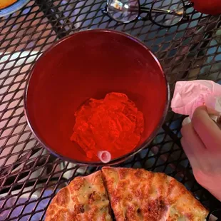 a hand holding a slice of pizza