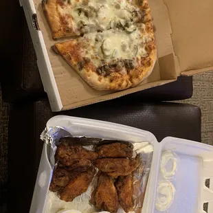 a box of chicken wings and a pizza