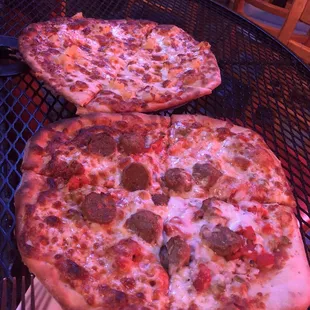 two pizzas on a table