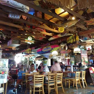 Interior with candy machines and various sea/surf-related items in the rafters.