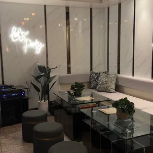 a living room with a couch, coffee table, and ottomans