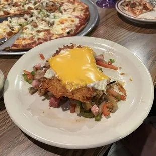 Everything Hashbrowns  Crispy hashbrowns with ham, green and hot peppers, onions, tomatoes, mushrooms, and cheese