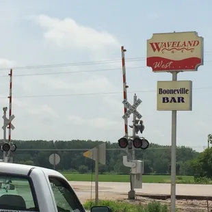a white truck parked next to a railroad crossing
