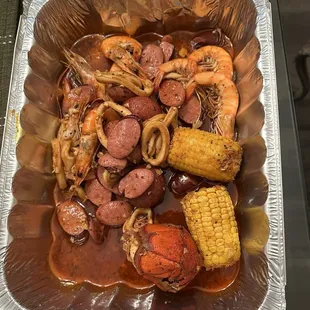 broil with corn &amp; potato&apos;s with calamari, shrimp, lobster tail &amp; sausage.