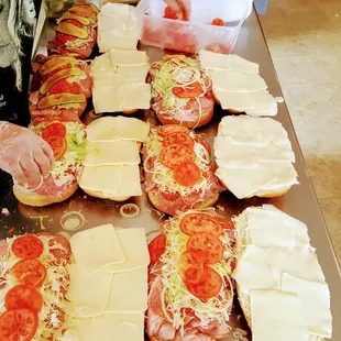a person preparing sandwiches