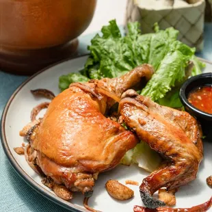 Somtum Gai Yang - Chicken grilled with spices. Served with papaya salad, Thai sweet and sour sauce, and sticky rice