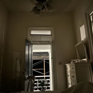 Sleeping with door propped open with fan outside, blowing cooler air in.