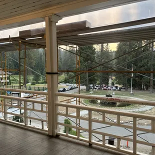 Grime hanging down from ceiling of porch, as well as scaffolding.