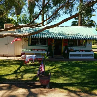a picnic area with tables and umbrellas