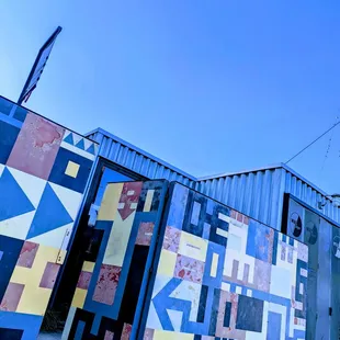 a colorful building with a blue sky in the background