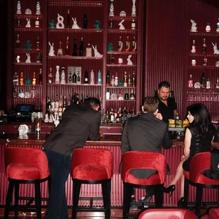 a group of people sitting at a bar
