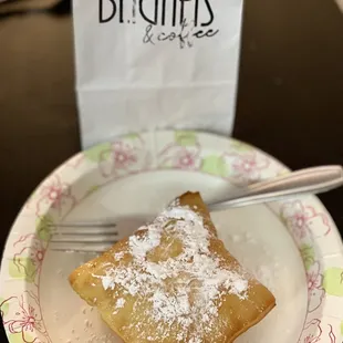 a piece of pastry on a plate with a fork