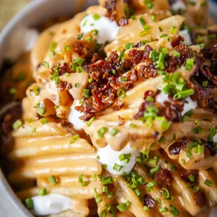 a bowl of pasta with bacon and cheese