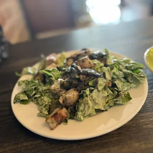 a plate of salad and a cup of coffee