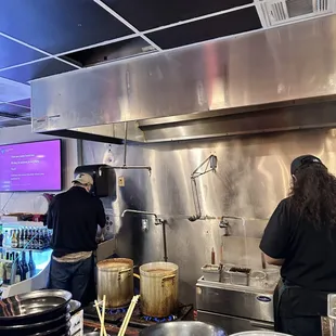 two people working in a kitchen