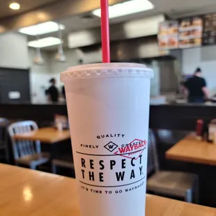 a plastic cup with a straw