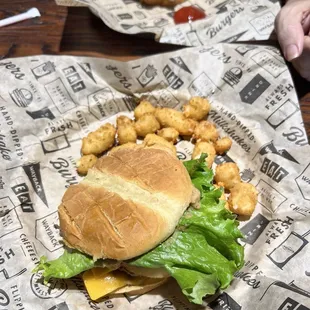 Bourbon burger with lettuce added, cheese curds, and the Classic burger with ketchup in the background.