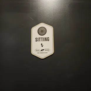 a sign on a black refrigerator