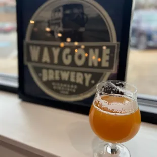 a glass of beer on a window sill