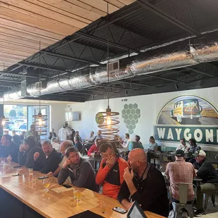 a large group of people sitting at a bar