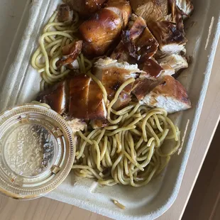 Plain noodles and dry chicken, after pouring generic teriyaki sauce on it.