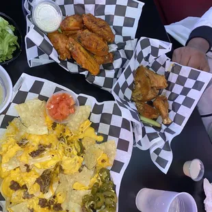 Chicken wings, chicken wings, ground beef nachos hold the lettuce and a side of jalapeños.