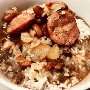 a bowl of stew with sausage and rice