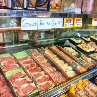 a variety of meats in a display case