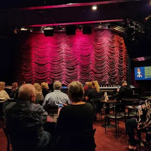 Sitting in the back row on a booth like seat in the back row.  Great seats!