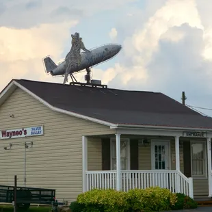 a silver bullet on top of a house