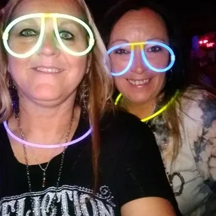 two women wearing neon glasses