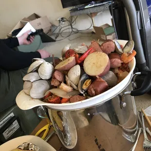 a large pot full of fruit and vegetables