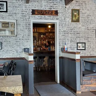 Dining room with the entry to the bar. This place is so unique and rustic.