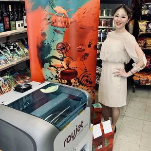 a woman standing next to a printer