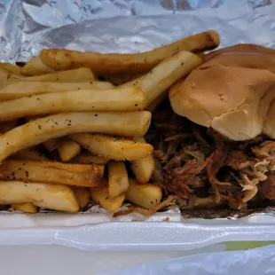 a pulled pork sandwich and french fries