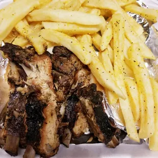 chicken and french fries in a styrofoam container